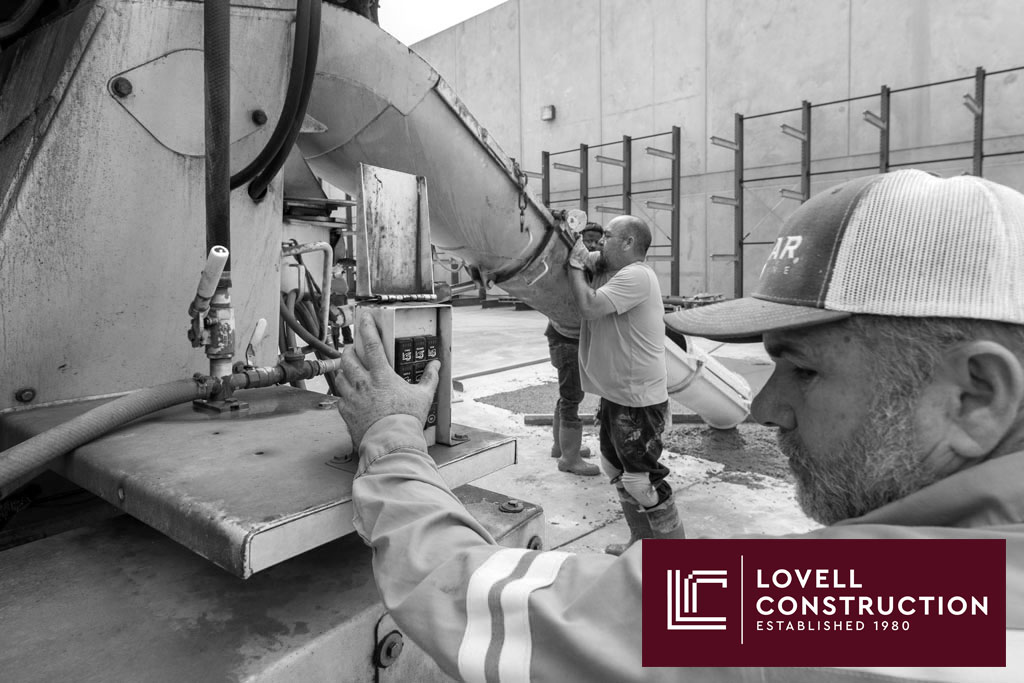 Image of a concrete truck pouring concrete around a storm drain